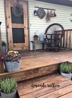 a wooden porch with potted plants on it