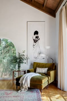 a living room filled with furniture and a painting on the wall