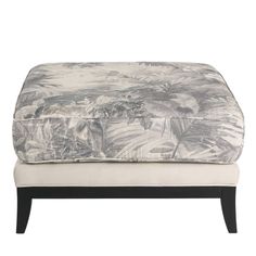 a foot stool with a tropical print on it