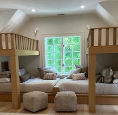 there are bunk beds in the room with pillows on them and stools underneath it