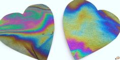 two heart shaped pieces are painted in different colors and shapes, one is multicolored