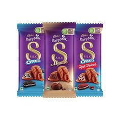 three bags of dairy milk with chocolate on the side