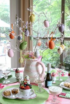 the table is set for an easter tea party with pink, green and white decorations