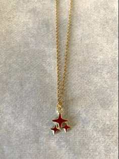 "Dainty, attractive and unique gold tone and red polar stars necklace. Pendant is small measuring 1/2\" L X 1/2\" W and is on an 18\" chain. ★ Want to see more? Please visit my shop at: https://www.etsy.com/shop/DesignsByPeg" Red Star Necklace, Gold Star Jewelry, Star Jewellery, Red Pendant Necklace, Stars Jewelry, Gold Star Pendant, Cute Necklaces, Stars Necklace, Pretty Accessories