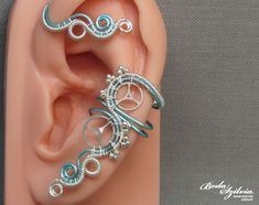 a pair of ear piercings made out of wire