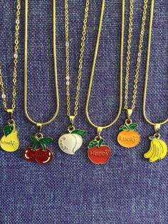 (12,056) Fruit with Positive Words Necklace or Earrings  Gold tone enamel charms Persimmon - >1/2" x <1/2" - Nice Pear - 3/4" x 1/2"  - Lovely Cherries - 3/4" x 5/8" - Smile Peach - <3/4" x <3/4" - Sweet Apple - <3/4" x >1/2" - Happy Orange - 3/4" x <1/2" - Lucky Banana- 3/4" x >1/2" - Money Cute Gold Enamel Jewelry, Cute Metal Charm Necklace Nickel Free, Cute Nickel-free Metal Charm Necklace, Cute Nickel-free Metal Charm Necklaces, Fun Nickel-free Metal Jewelry, Novelty Gold Pendant Jewelry, Cute Gold Jewelry With Vintage Charm, Nickel-free Enamel Pendant Charm Necklace, Gold Novelty Round Jewelry