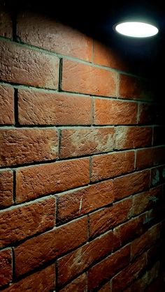 a brick wall with a light on it