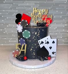 a birthday cake with casino chips and cards