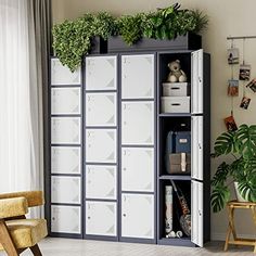 a white and black cabinet with plants on it's sides in a living room