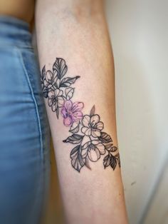 a woman with a flower tattoo on her arm