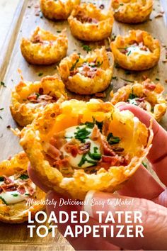 a person holding up a loaded tater to appetizer