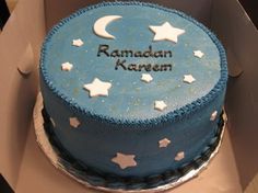 a blue cake with white stars and the words raman kareem on it