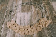 a close up of a wreath on a wooden floor with a metal ring around it