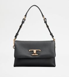 Crafted in soft calfskin leather, this mini bag comes with the branded metal T Timeless turn-lock buckle. Featuring adjustable and interchangeable handle and shoulder strap, it comes with a suede interior, divided in three practical compartments. A versatile and feminine creation, perfect for your everyday look. Tods Bag, Kathryn Newton, Micro Bags, Handbags Online, Bags And Accessories, Leather Items, Flap Bag, Leather Mini, Everyday Look