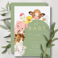 a baby shower with farm animals on it and greenery in the foreground, next to a green frame