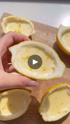 someone is peeling an egg shell on a cutting board with the peels still in it