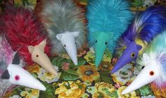 five different colored feathers are arranged in a circle on a floral tablecloth with flowers