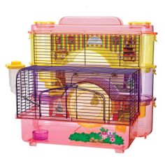 a pink and yellow hamster cage sitting on top of a table