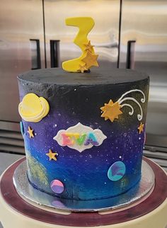 a colorful cake with stars and planets on it