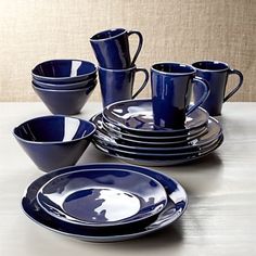 a set of blue dishes and cups on a table