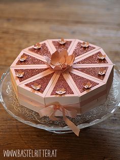 a decorative pink box on a glass plate