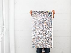 a person holding up a large poster with many different pictures on it's sides