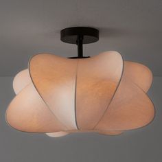 a close up of a light fixture on a ceiling in a room with gray walls