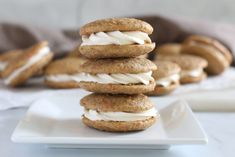 three cookies stacked on top of each other with white frosting and graham crackers