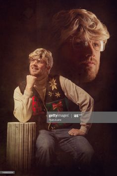 two men sitting next to each other in front of a dark background