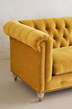 a white couch sitting on top of a hard wood floor