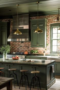 a kitchen with green cabinets and stools in front of the counter top is surrounded by wooden flooring