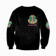 the back of a black sweatshirt with pink and green patches on it, featuring an emblem