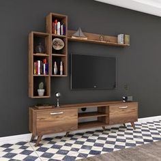 an entertainment center with bookshelves and a television on it's stand in a living room