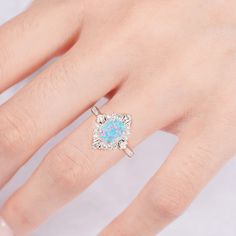 The Mei Blue Fire Opal Ring is stunning—it’s the kind of ring you put on and never want to take off. At the center, there’s a blue fire opal that flashes electric blue every time it moves. It’s one of those stones that feels alive, like it’s got its own little light show going on. Around the opal, there are small natural crystals that keep it classy. The sterling silver band pulls the whole look together—sleek, simple, and perfect for showing off that glowing centerpiece. Every ring is handmade, Blue Opal Ring With Accent Stones As Gift, Blue Opal Anniversary Rings, Blue Opal Promise Ring, Silver Opal Birthstone Ring Fine Jewelry, Blue Opal Rings For Anniversary, Blue Round Opal Ring, Turquoise Opal Rings Perfect For Gifts, Blue Opal Round Ring, Turquoise Opal Rings As Gift