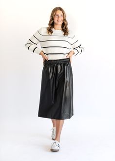 The Vegan Leather A-line Midi Skirt is equal parts stretchy and comfortable! This high-rise midi skirt features an elastic waistband, side pockets, and a beautiful a-line silhouette for movement with each step. Style this black faux leather skirt with your favorite sweater and sneakers all season long! Style | A-line, Midi Color | Black SIZING TIPS Fit | Semi-Fitted Stretch | Mid-Stretch Model | True to Size Aline Midi Skirt, Black Faux Leather Skirt, Maxi Skirt Dress, Denim Maxi Skirt, Denim Midi Skirt, Favorite Sweater, Faux Leather Skirt, Long Style, Colored Denim