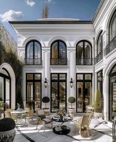 an artist's rendering of a large white house with black windows and balconies