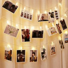 a string of lights hanging from a curtain with pictures on it and photos attached to the strings