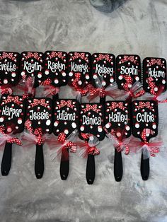 six black and red minnie mouse toothbrushes with name tags on them