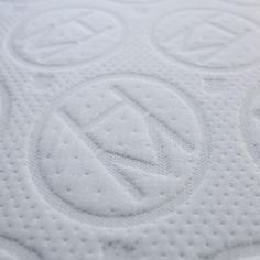 close up view of the top part of an unmade mattress with circles on it