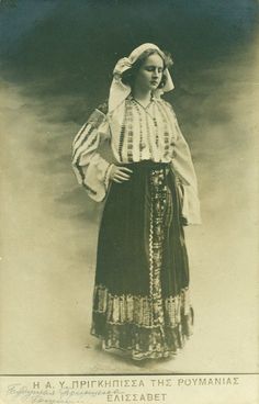 an old black and white photo of a woman wearing a dress with stripes on it