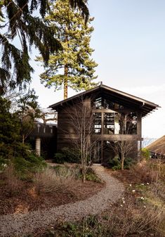 the house is made out of wood and has a walkway leading up to it's roof