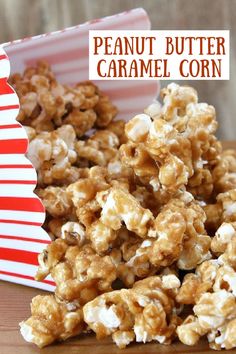 a pile of popcorn sitting on top of a table next to a red and white striped box