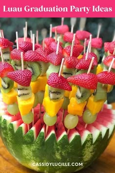 a watermelon bowl filled with fruit and kiwis