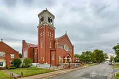 an old red brick church with a clock tower