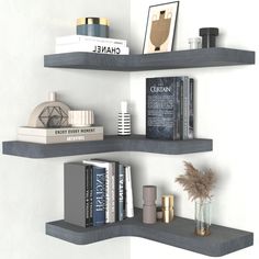 two shelves with books and vases on them