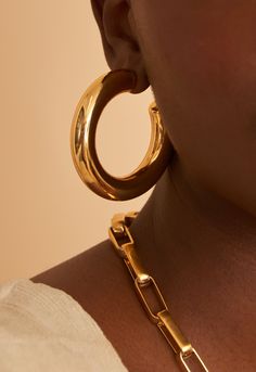 Is a statement piece that takes inspiration from that all time classic shaped hoop we all know and love. The thicker frame is bold in fashion and works to glam out any look. The Chubby hoops are our thickest and most lightweight hoop and we have worked so hard to bring you this to life and we are so excited that you can finally shop it! Our Chubby Hoops are the only hoops you’ll ever need. Chic, bold and versatile, these thick gold-plated hoop earrings are trendy but timeless. Every woman should Urban Jewelry, Hoop Dreams, Chunky Earrings, Hoops Gold, Jewelry Branding, Every Woman, In Fashion, The Label, Statement Earrings