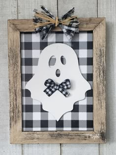 a wooden frame with a black and white checkered bow on it