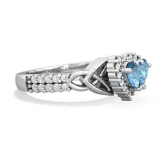 an oval blue topazte and diamond ring with two rows of diamonds around it