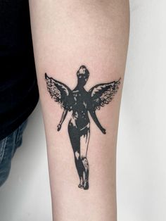 a woman with an angel tattoo on her arm