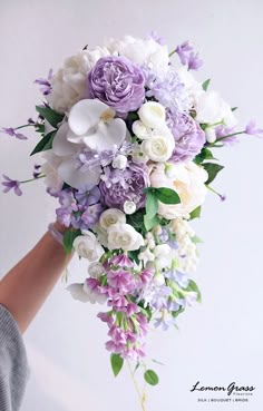 a bridal bouquet with purple and white flowers